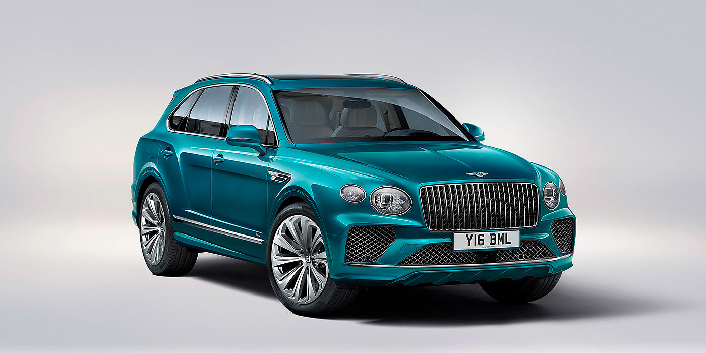 Bentley Birmingham Bentley Bentayga Azure front three-quarter view, featuring a fluted chrome grille with a matrix lower grille and chrome accents in Topaz blue paint.