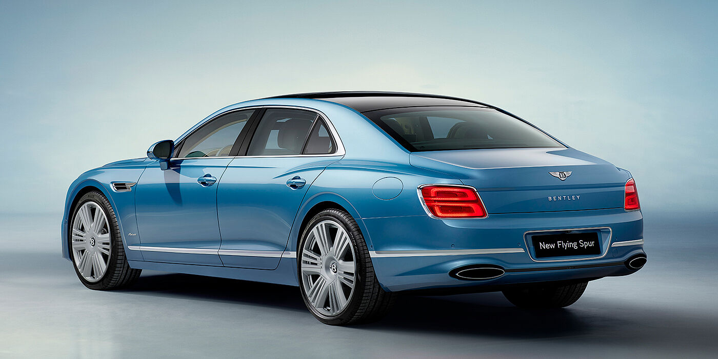 Bentley Birmingham New Bentley Flying Spur Azure sedan rear view in Light windsor blue by Mulliner paint with 22 inch Azure wheels and chrome exterior details
