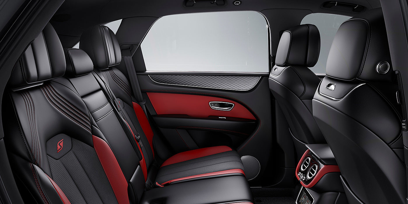 Bentley Birmingham Bentey Bentayga S interior view for rear passengers with Beluga black and Hotspur red coloured hide.