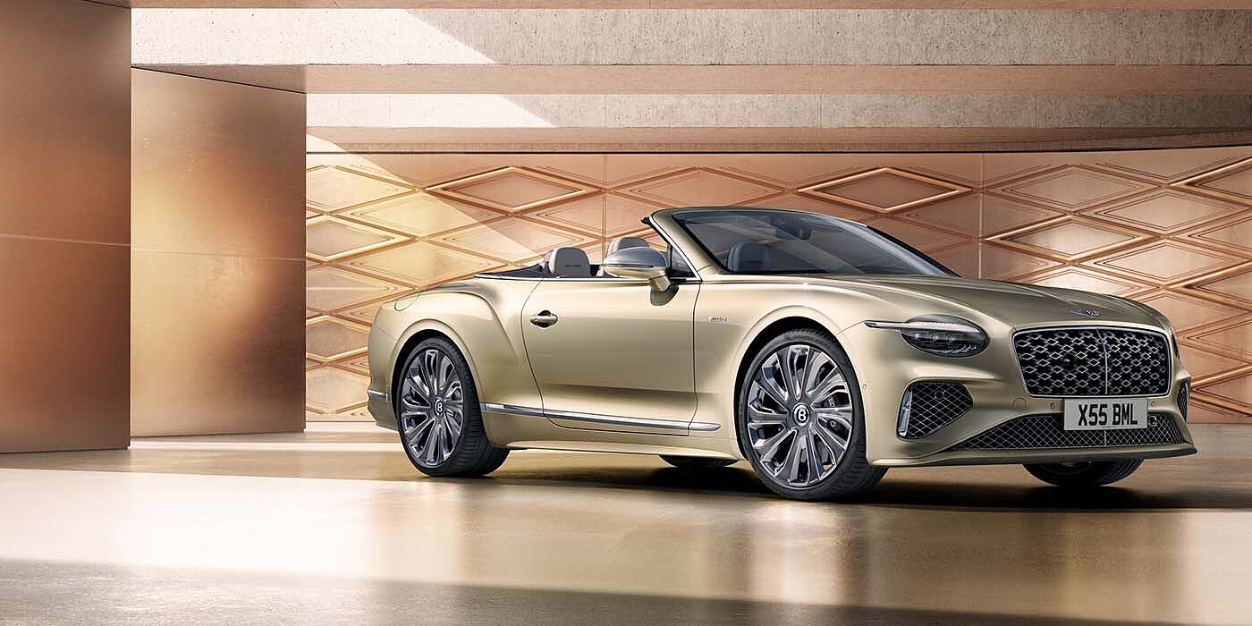 Bentley Birmingham Bentley New Continental GTC Mulliner V8 hybrid front three quarters in Patina paint