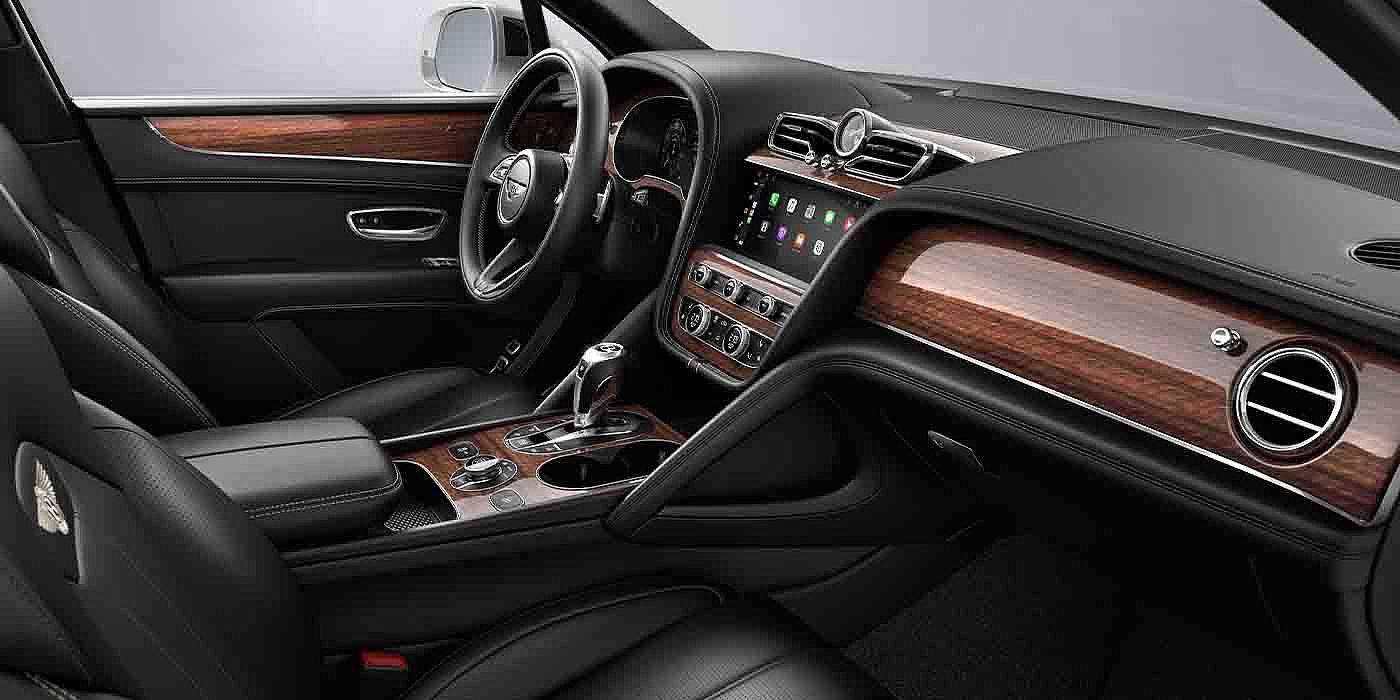 Bentley Birmingham Bentley Bentayga EWB interior with a Crown Cut Walnut veneer, view from the passenger seat over looking the driver's seat.