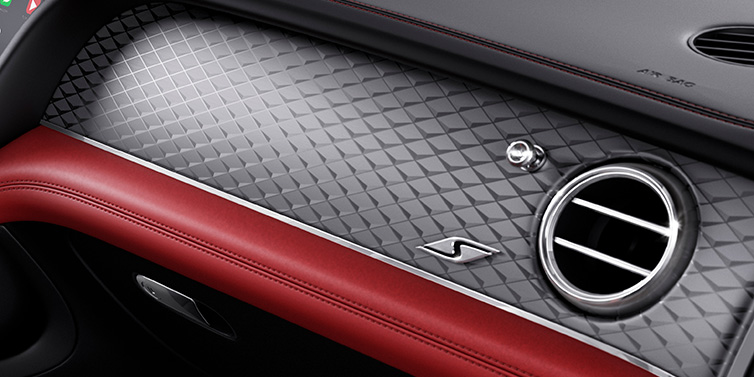 Bentley Birmingham Bentley Bentayga S SUV front interior dash with Dark Tint Diamond Brushed Aluminium veneer and S badge surrounded by Hotspur red and Beluga black hide