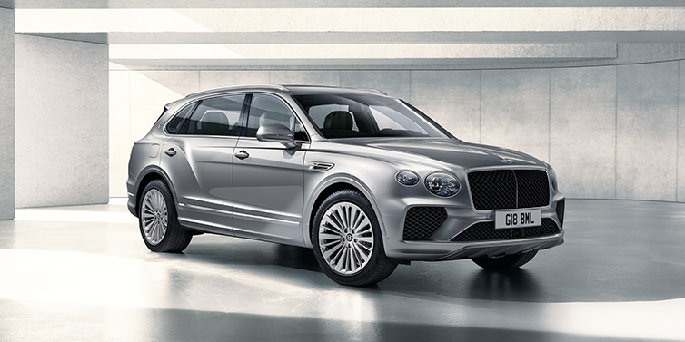 Bentley Birmingham Bentley Bentayga Extended Wheelbase SUV front three quarter in Moonbeam paint with a grey background