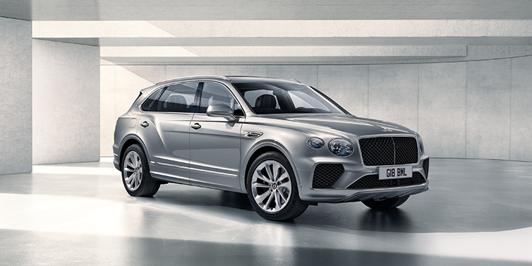 Bentley Birmingham Bentley Bentayga Extended Wheelbase SUV front three quarter in Moonbeam paint with a grey background