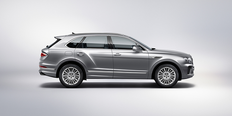 Bentley Birmingham Bentley Bentayga SUV side profile in Moonbeam silver paint against white background featuring 21 inch 5 spoke wheels
