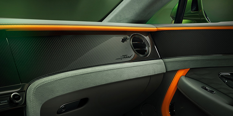 Bentley Birmingham Bentley Continental GT Speed coupe front interior dash detail with high gloss carbon fibre veneer surrounded by Mandarin by Mulliner and Gravity Grey hides