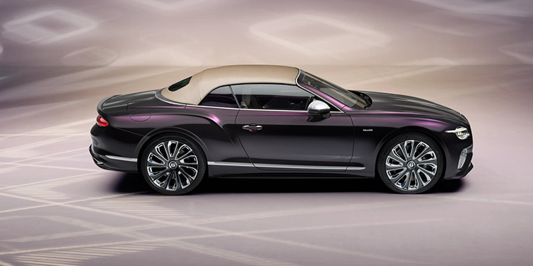 Bentley Birmingham Bentley Continental GTC Mulliner convertible in profile with hood up, in Tanzanite Purple paint and 22 inch Mulliner painted and polished wheels