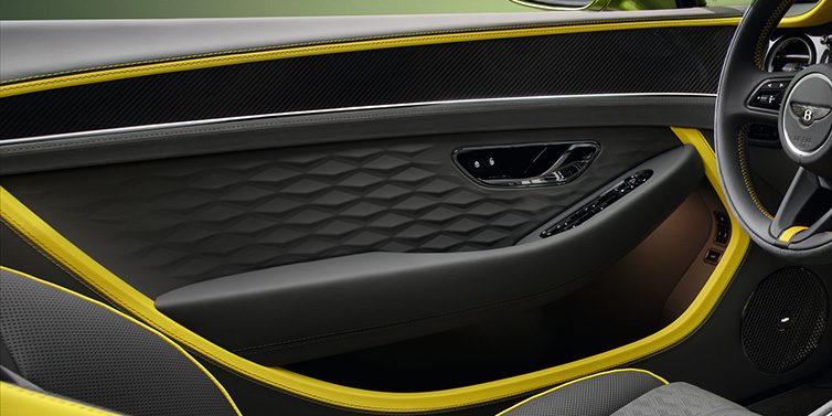 Bentley Birmingham Bentley Continental GTC Speed convertible interior door details featuring Gravity Grey and Cyber Yellow by Mulliner hides and high gloss carbon fibre veneer