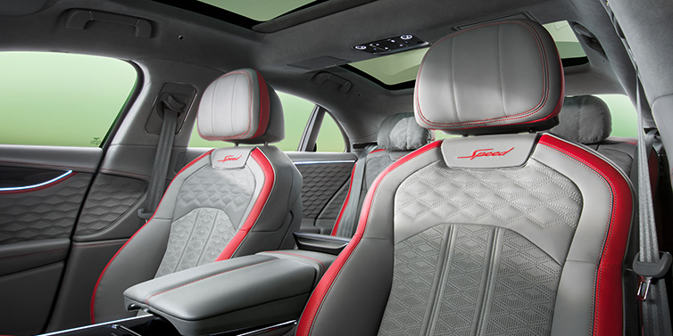 Bentley Birmingham Bentley Flying Spur Speed sedan interior showing front and rear seats in Hotspur red and Gravity Grey hides, with Speed seat emblems