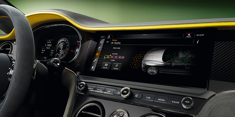 Bentley Birmingham Bentley Continental GTC Speed convertible front interior centre console with MMI screen showing Air Quality visualisation surrounded by Cyber Yellow by Mulliner and Gravity Grey hides and high gloss carbon fibre veneer