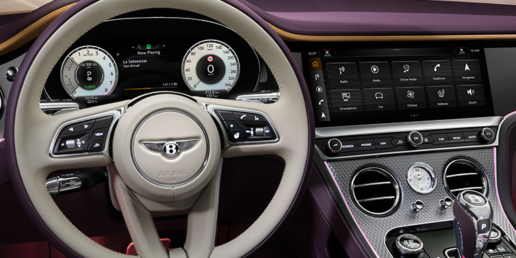 Bentley Birmingham Bentley Continental GTC Mulliner convertible steering wheel and drivers screens surrounded by Damson purple and Linen hides